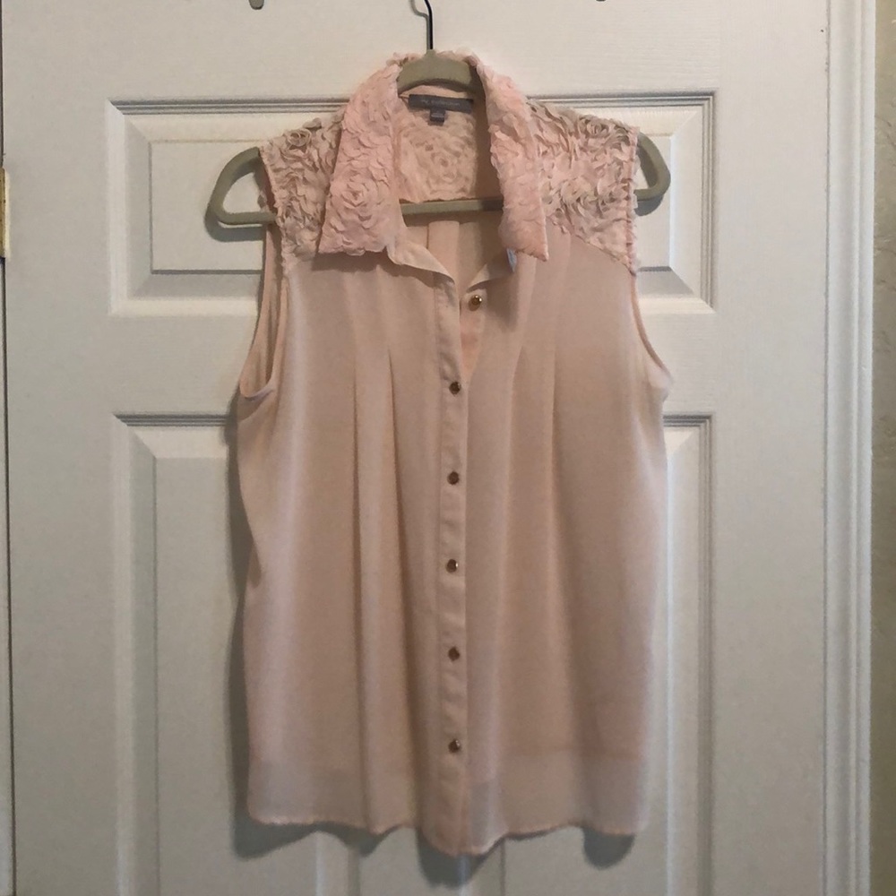 Blush pink sleeveless blouse.